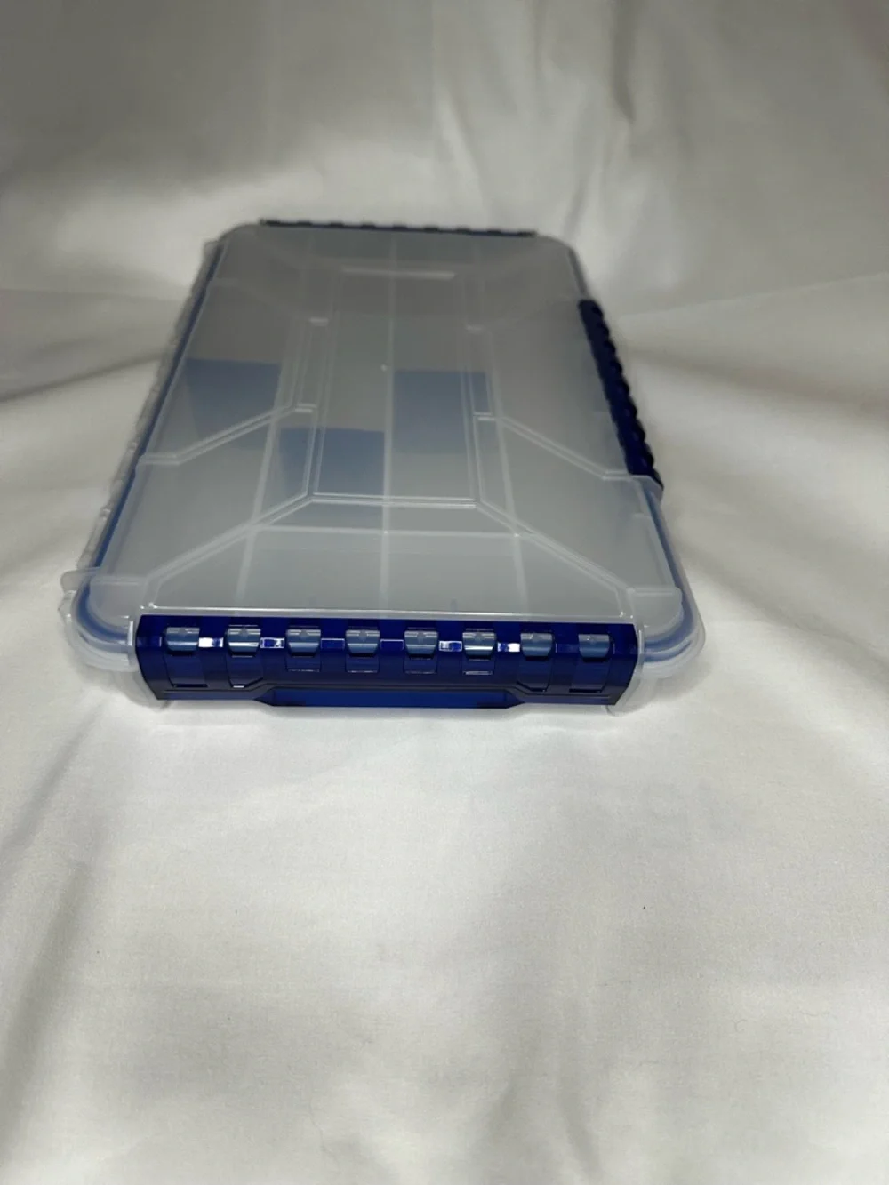 Multi-Compartment Clear Plastic Storage Box with Blue Accents.